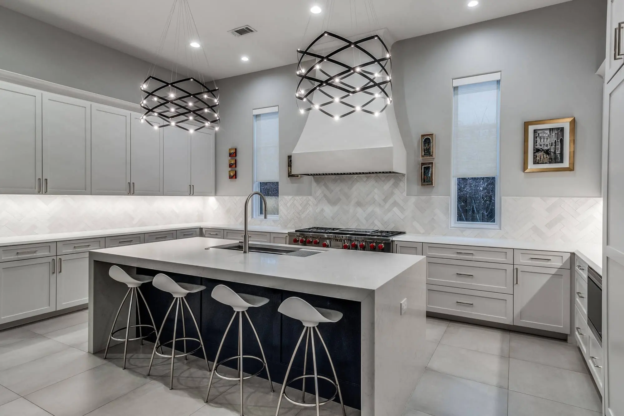 Modern kitchen with gray painted cabinets and a waterfall island, cabinet painting and refinishing in Dallas, Texas