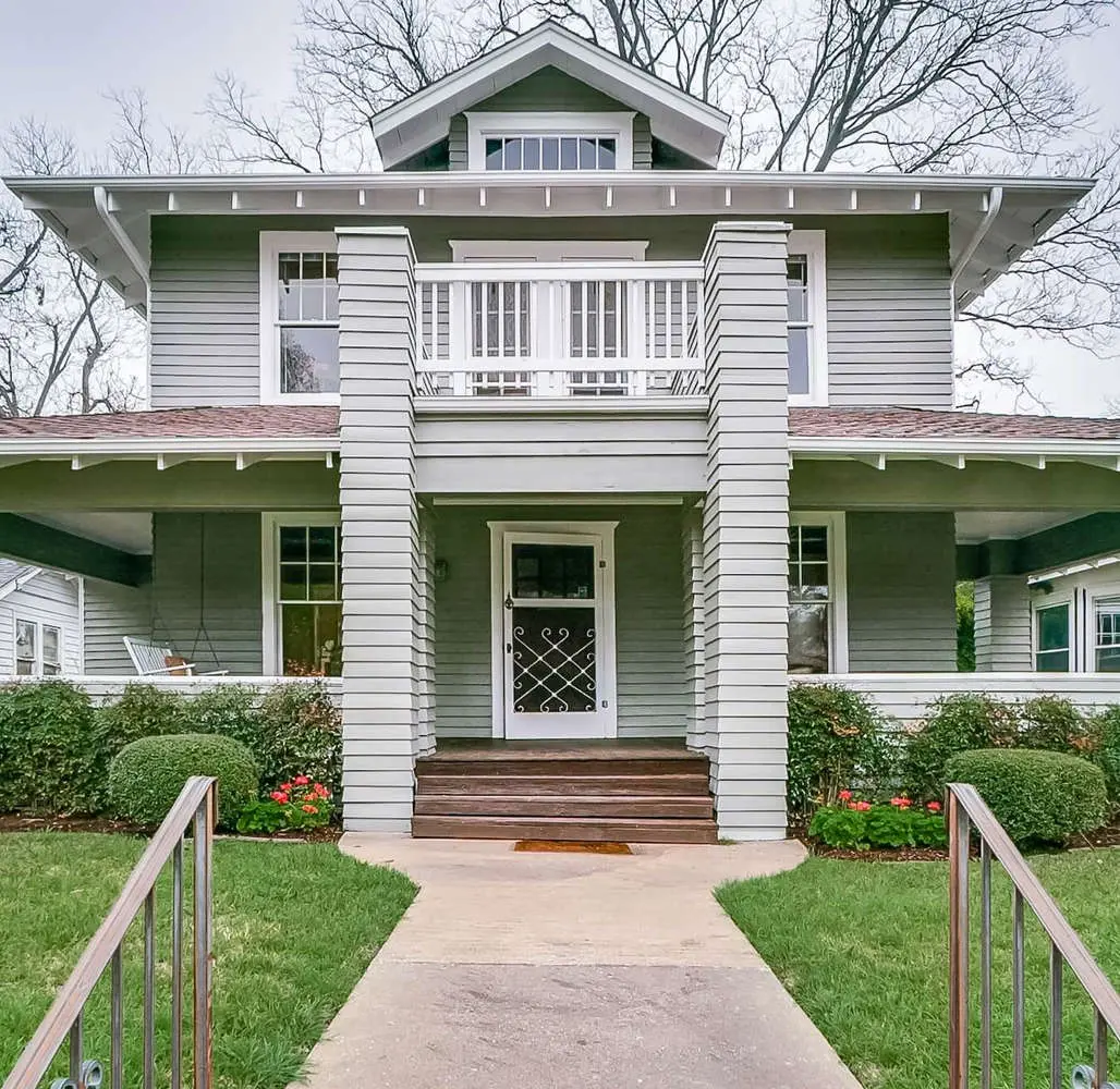 Two-story craftsman home with sage green siding and crisp white trim painted by San Miguel Painting in Dallas, Texas