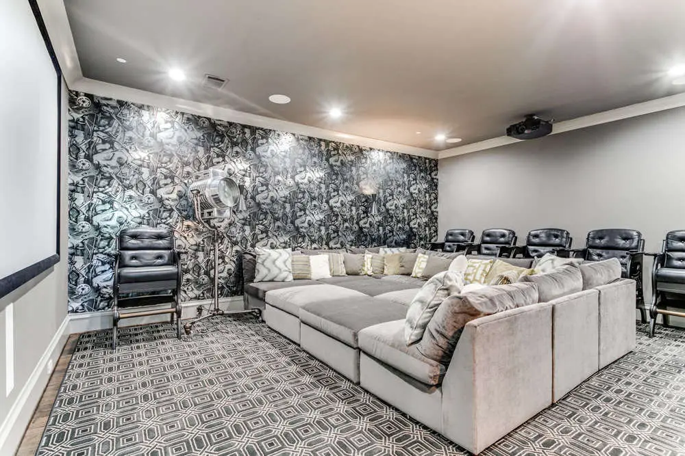 Media room with light gray walls, white trim and a bold black floral accent wall, San Miguel Painting project in Dallas, Texas
