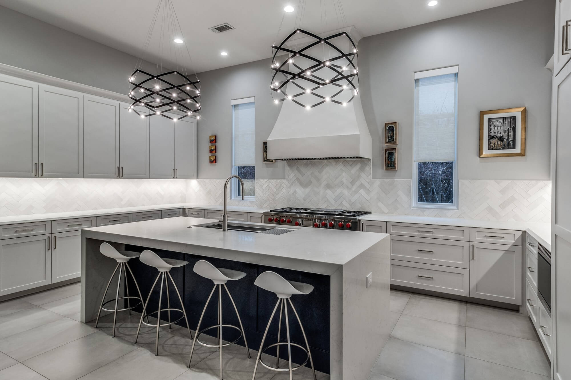 Modern kitchen with gray painted cabinets and a waterfall island, cabinet painting and refinishing in Dallas, Texas