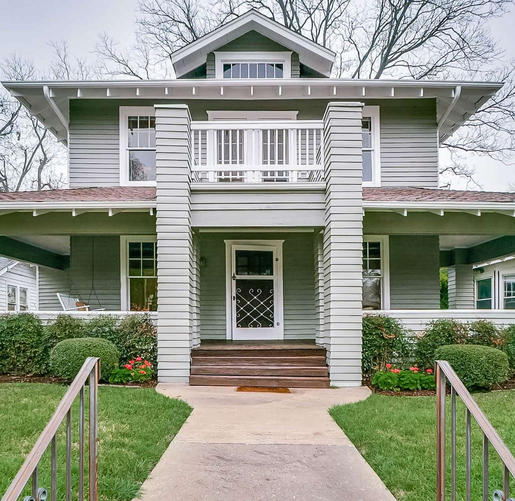 Two-story craftsman home with sage green siding and crisp white trim painted by San Miguel Painting in Dallas, Texas