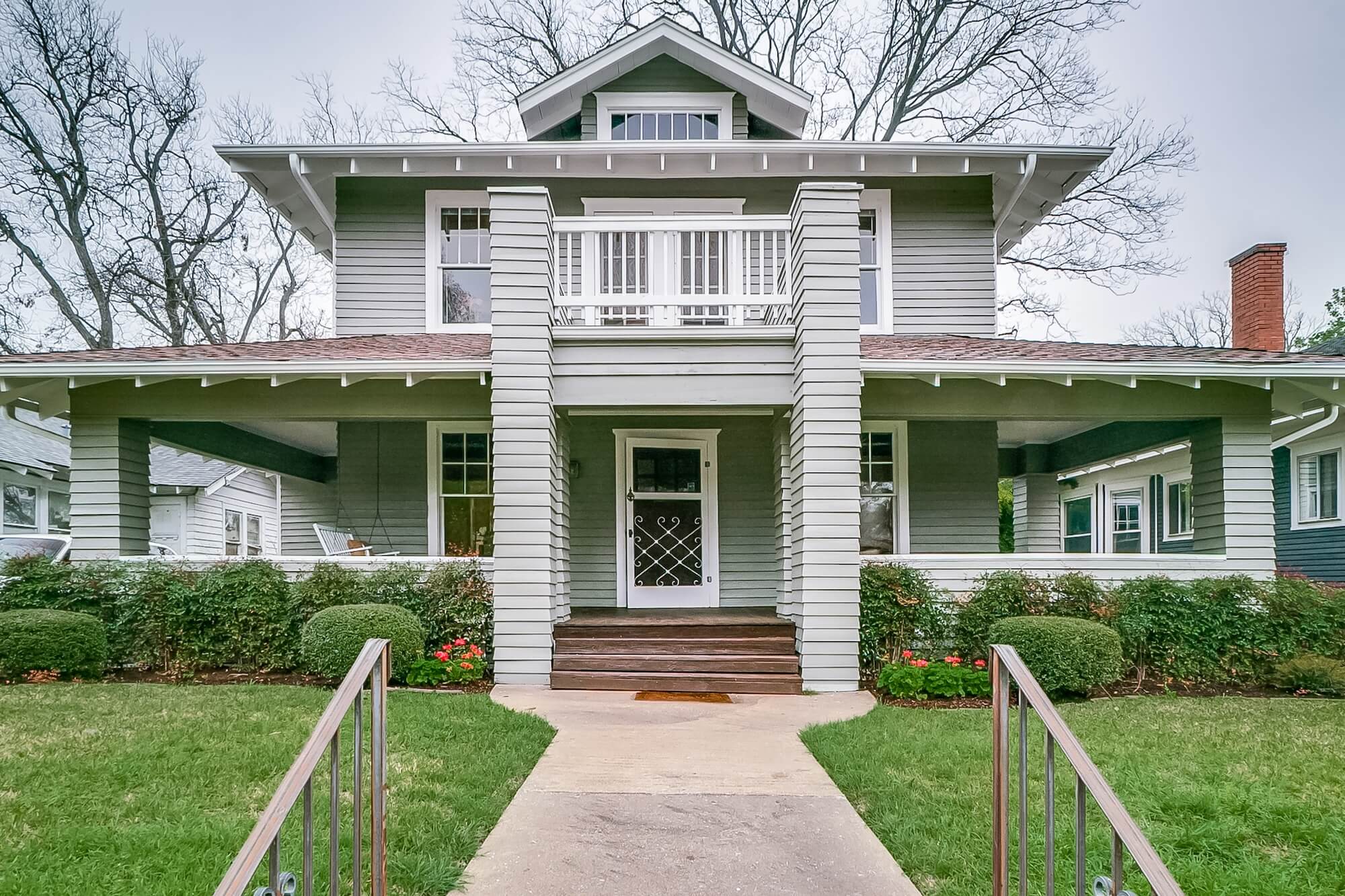 Two-story craftsman home with sage green siding and crisp white trim painted by San Miguel Painting in Dallas, Texas