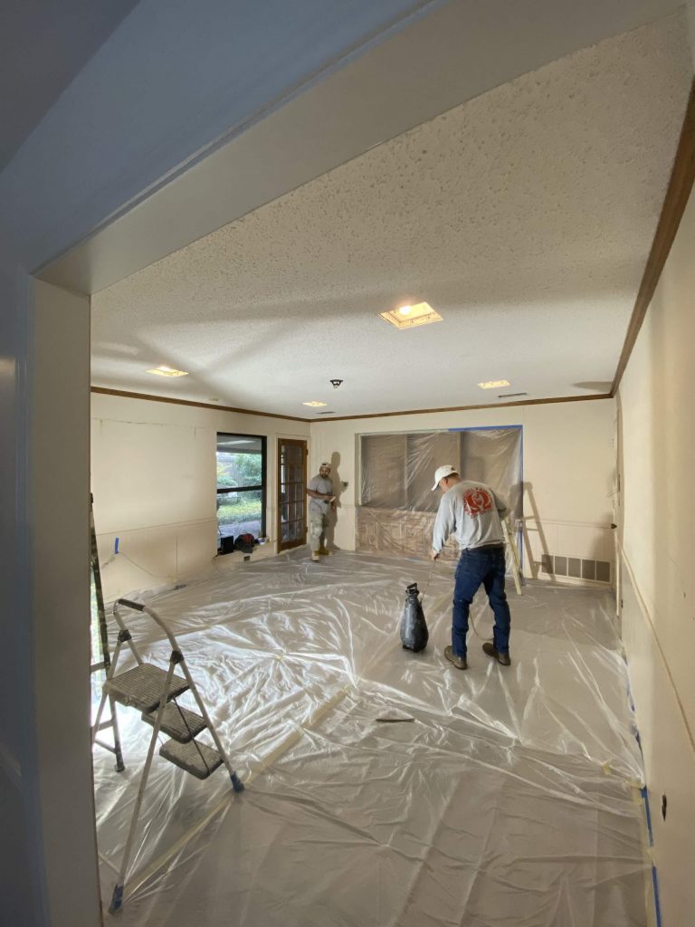 San Miguel Painting crew preparing a living room for interior painting with floor protection in Dallas, Texas