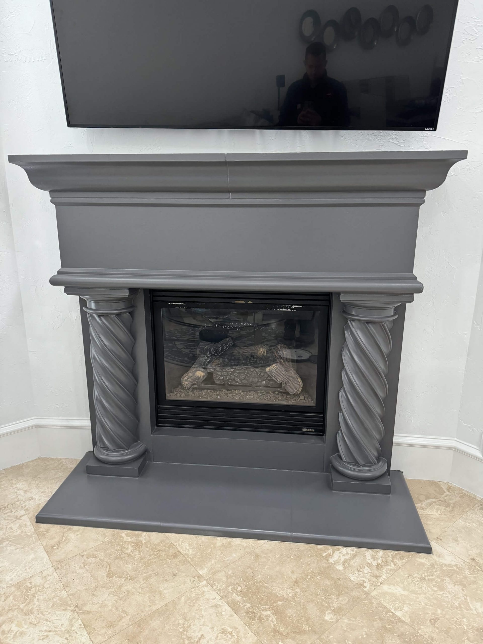 Fireplace mantel with twisted columns painted in charcoal gray by San Miguel Painting in Dallas, Texas