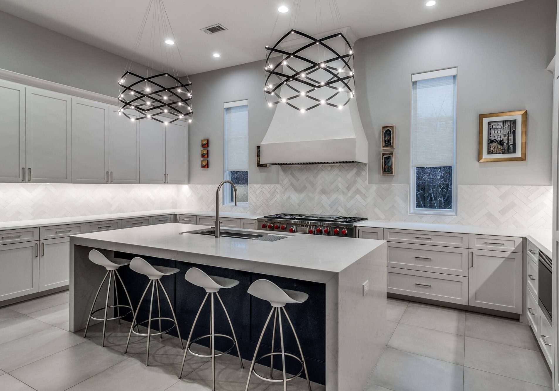 Modern kitchen with gray painted cabinets and a waterfall island, cabinet painting and refinishing in Dallas, Texas