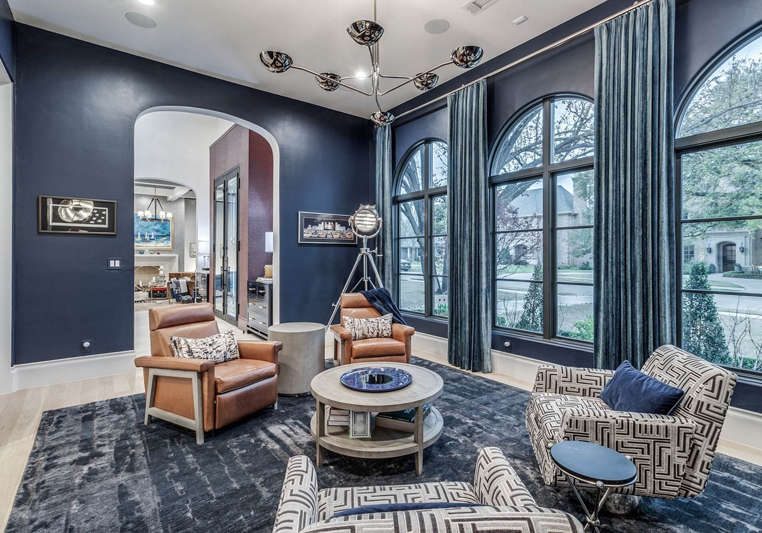 Sitting room with deep navy blue walls and arched black windows painted by San Miguel Painting in Dallas, Texas